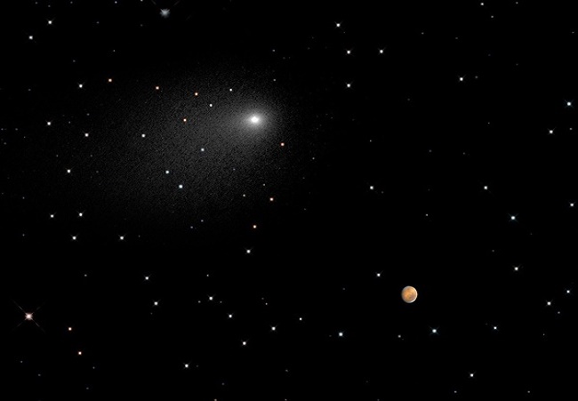 Comet Siding Spring passing by Mars. Photo courtesy of NASA.