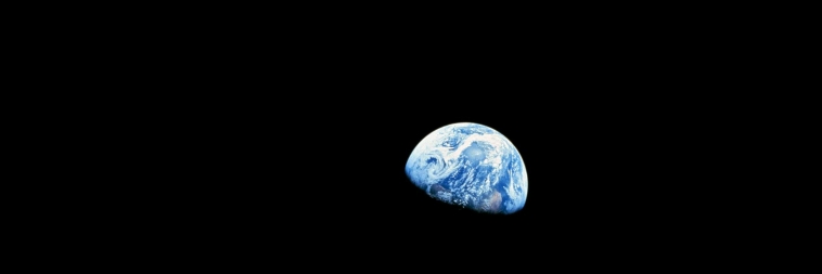 A view of the Earth from the Moon, surrounded by darkness, opening our article exploring the question: Why Is Space Black?