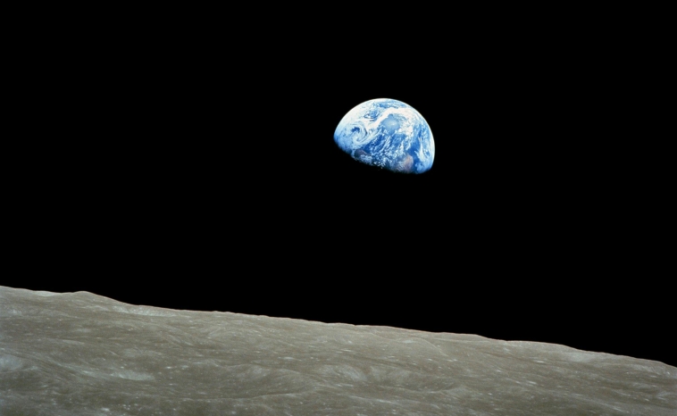 A view of the Earth from the Moon, surrounded by darkness, opening our article exploring the question: Why Is Space Black?