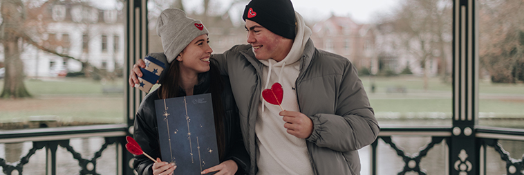Man and woman giving eachother a unique Valentine's gift